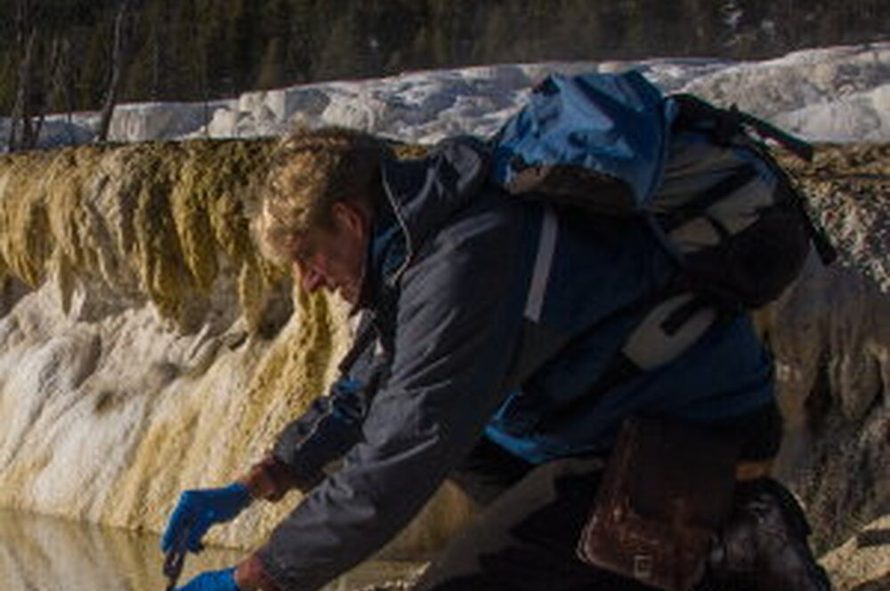 Dr. Bruce Fouke sampling water at Yellowstone National Park