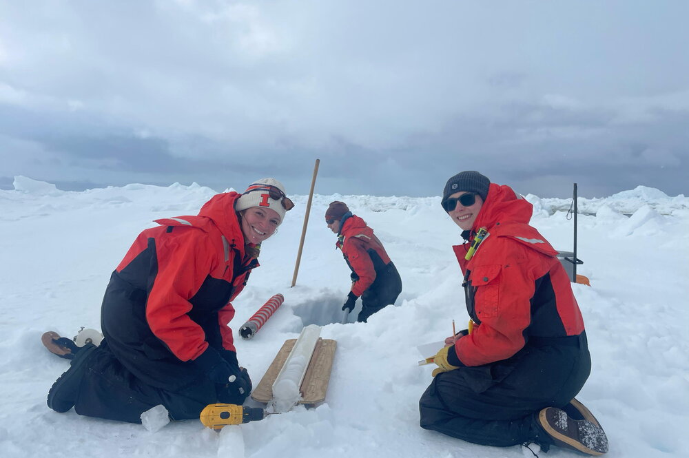 Scientists taking ice core samples in antarctica.