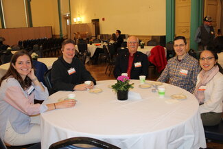 A group of people sitting around a table.