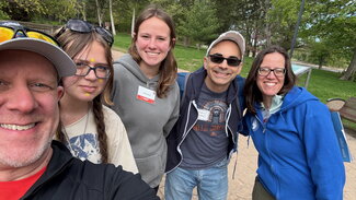 A group of people pose for a selfie