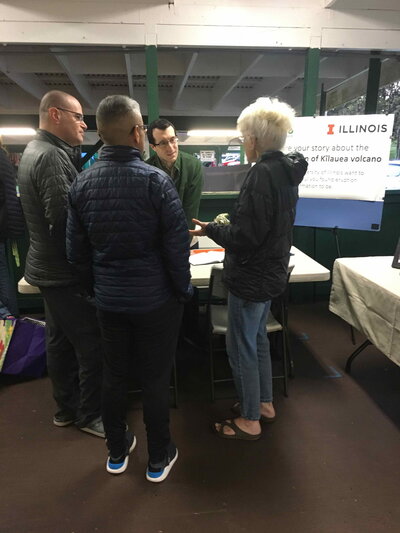 People gathered around a table talking.