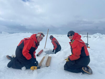Scientists taking ice core samples in antarctica.