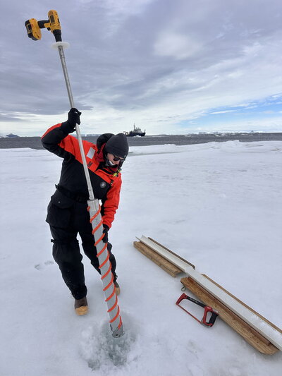 A person holding an ice drill.