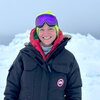 A person standing on ice in winter gear.