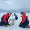 Scientists taking ice core samples in antarctica.
