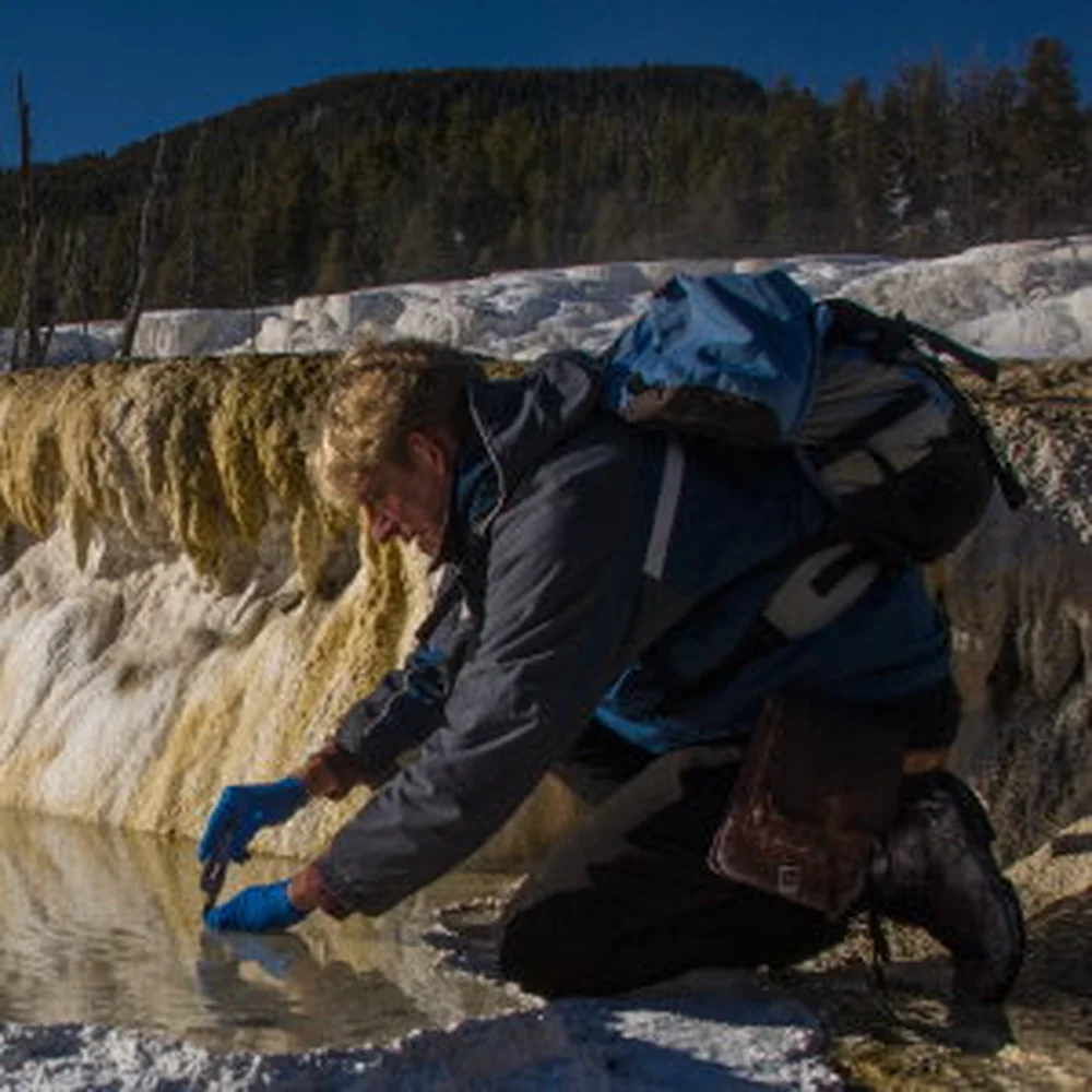 Dr. Bruce Fouke sampling water at Yellowstone National Park