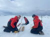 Scientists taking ice core samples in antarctica.